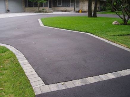 New asphalt driveway with paver edging